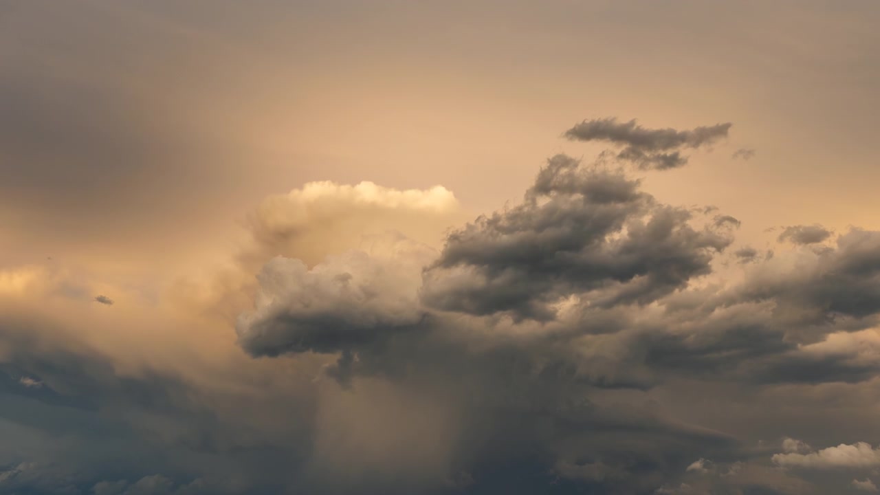 Dramatic sunset sky filled with glowing clouds and dark weather tones