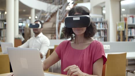 front view of cheerful caucasian woman wearing vr headset