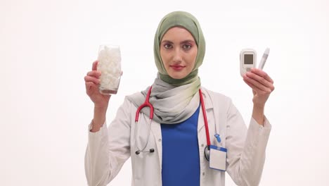 female doctor with blood glucose meter and sugar cubes for diabetes awareness
