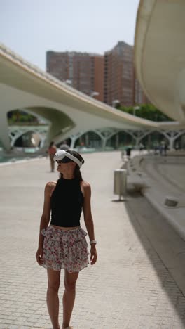 woman wearing vr headset in a city park