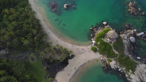 Tropical-beach-coastline-and-Cabo-de-San-Juan-bungalow-in-Tayrona-at-sunset