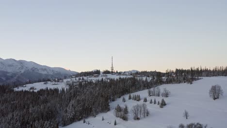zakopane-gubalowka transmitter tower with dense forest and snowy gubalowka mountain at zakopane, poland