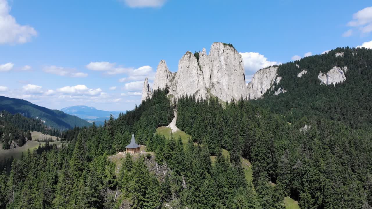 루마니아 하마술 마레에 있는 피아트라 싱구라티카의 상록수 숲 위로 솟아 있는 외로운 바위의 파노라마