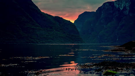 time lapse shot of cruise ship arriving fjord in norway during sunset light in norway