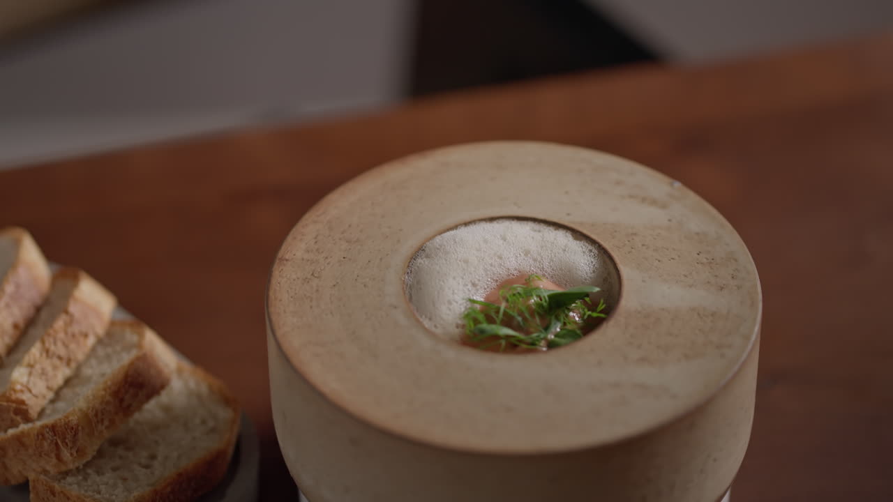 A bowl of soup with bread on the side