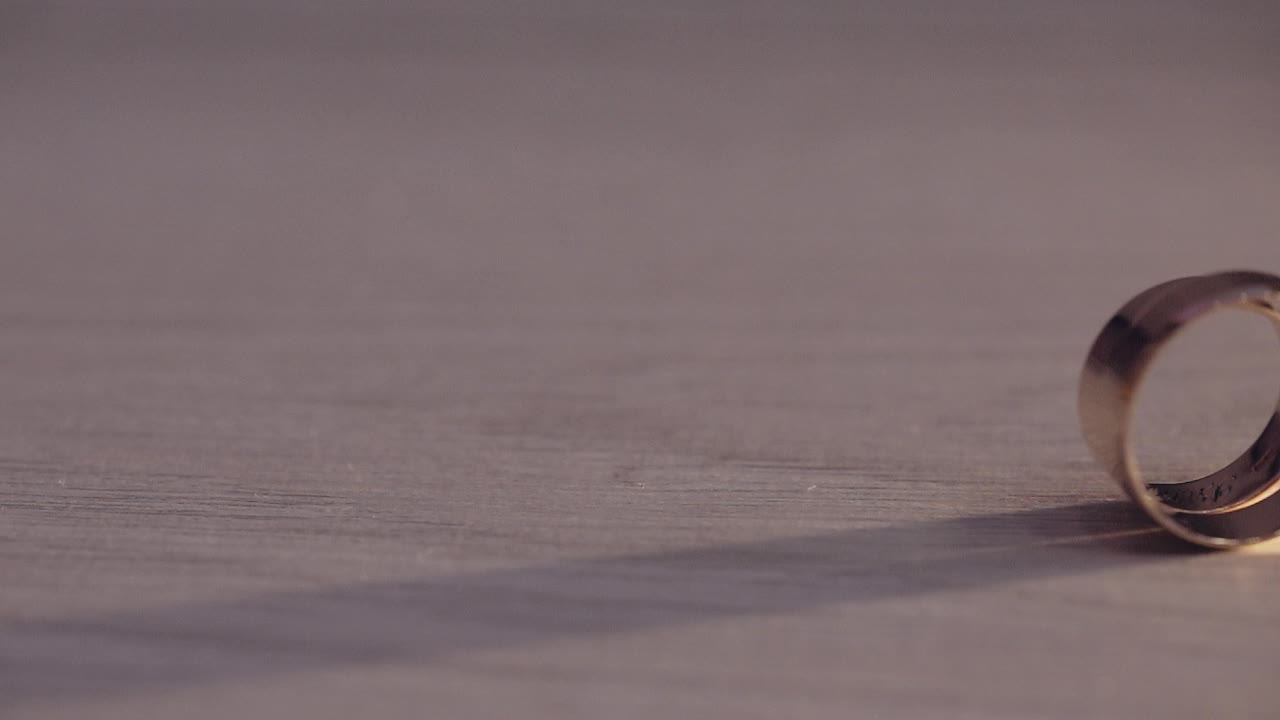 Two wedding rings rolling on the floor