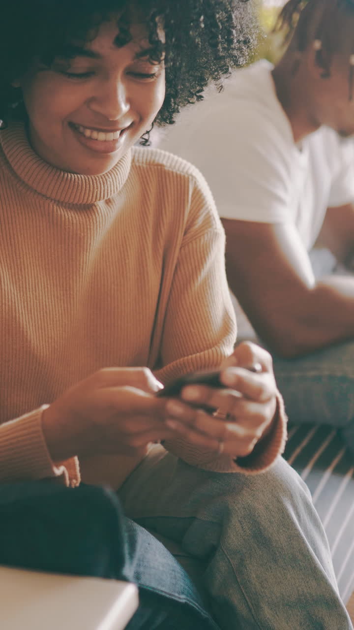 Young Woman Smiling and Using Smartphone Indoors