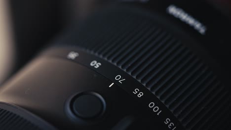 macro close up of the focal length numbers on a cameras zoom lens as the photographer zooms in and out