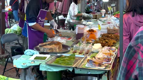 vendor preparing food at a bustling market stall