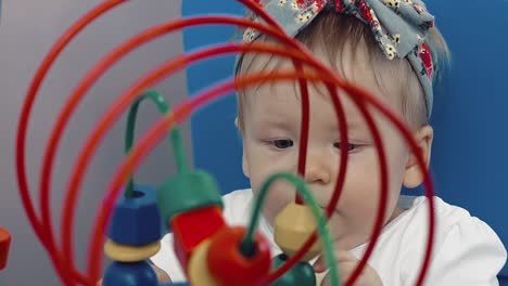 child plays with a multi-colored toy 13