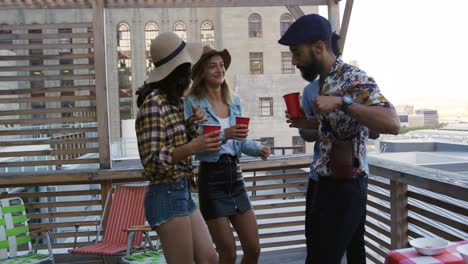 young adult friends hanging out on a rooftop