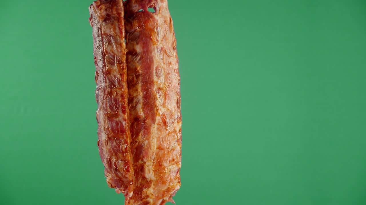 Raw ribs in tomato sauce hang.