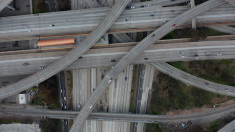 AERIAL:-Slow-Overhead-Flighty-Shot-of-Judge-Pregerson-Highway-showing-multiple-Roads,-Bridges,-Viaducts-with-little-car-traffic-in-Los-Angeles,-California-on-Beautiful-Sunny-Day
