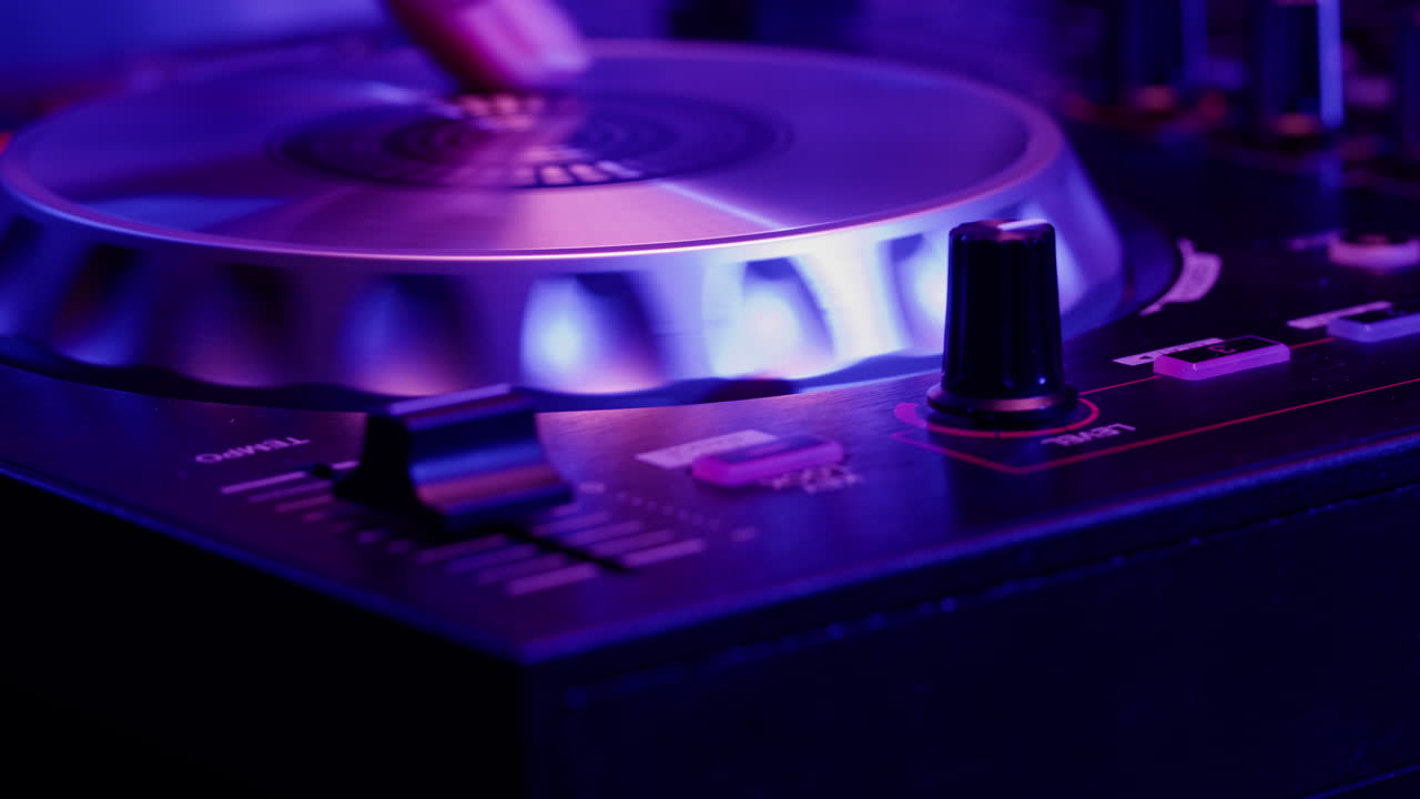 DJ with headphones and sunglasses playing music on festival in night club. Techno musician performing at nightclub for concert crowd of people, city bar.
