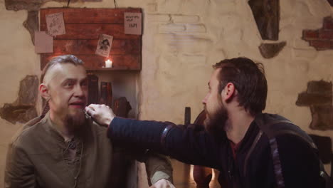 two men talking in a medieval tavern