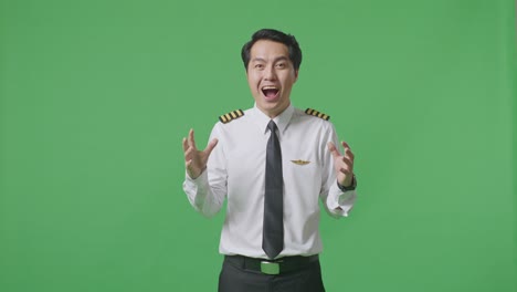 Asian Man Pilot Smiling And Saying Wow While Standing In The Green Screen Background Studio