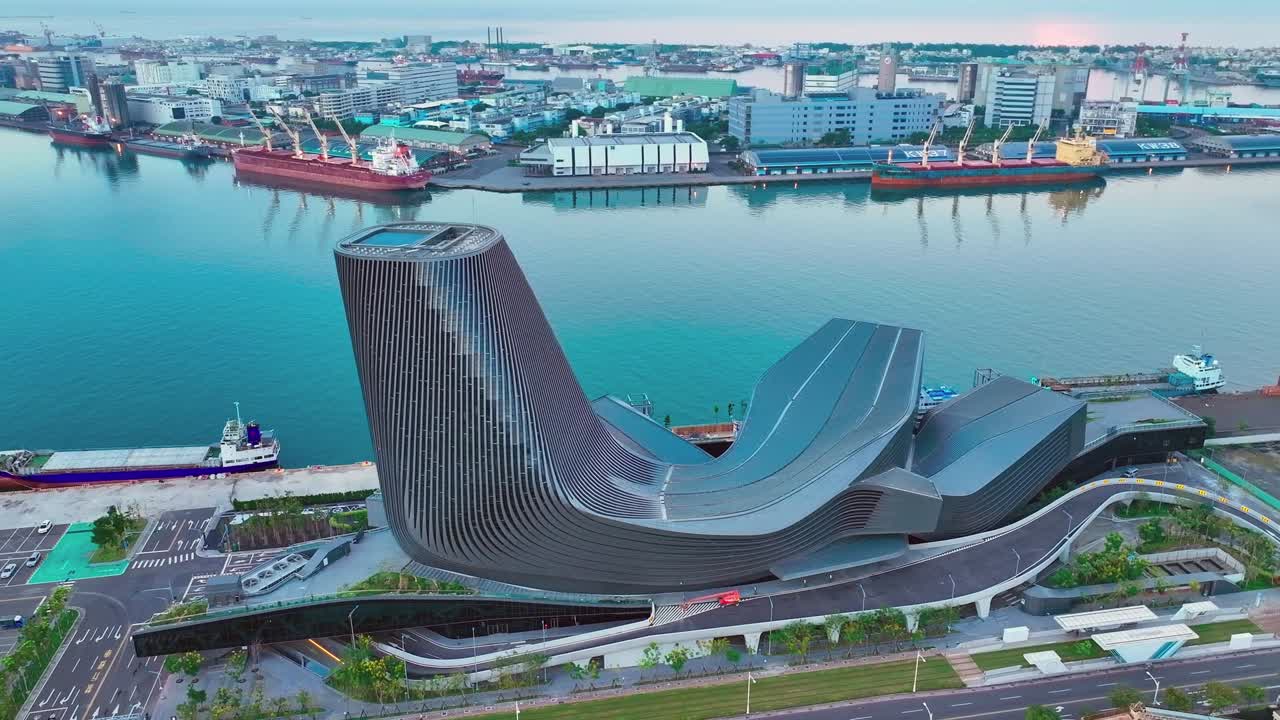 Aerial view showing modern architecture of Kaohsiung Cruise Terminal in Taiwan with dockings industrial ships