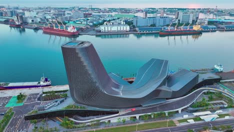 aerial view showing modern architecture of kaohsiung cruise terminal in taiwan with dockings industrial ships