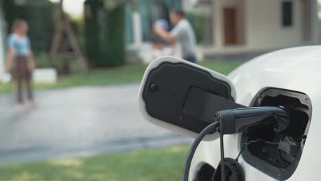 progressive parent have returned from picking up daughter at school with ev car.