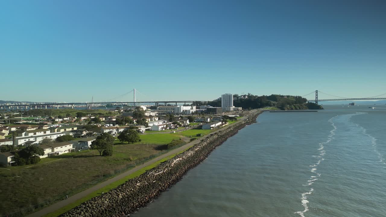 Pan drone shot of Treasure Island and San Francisco-Oakland Bay Bridge with Pacific Ocean in California, USA