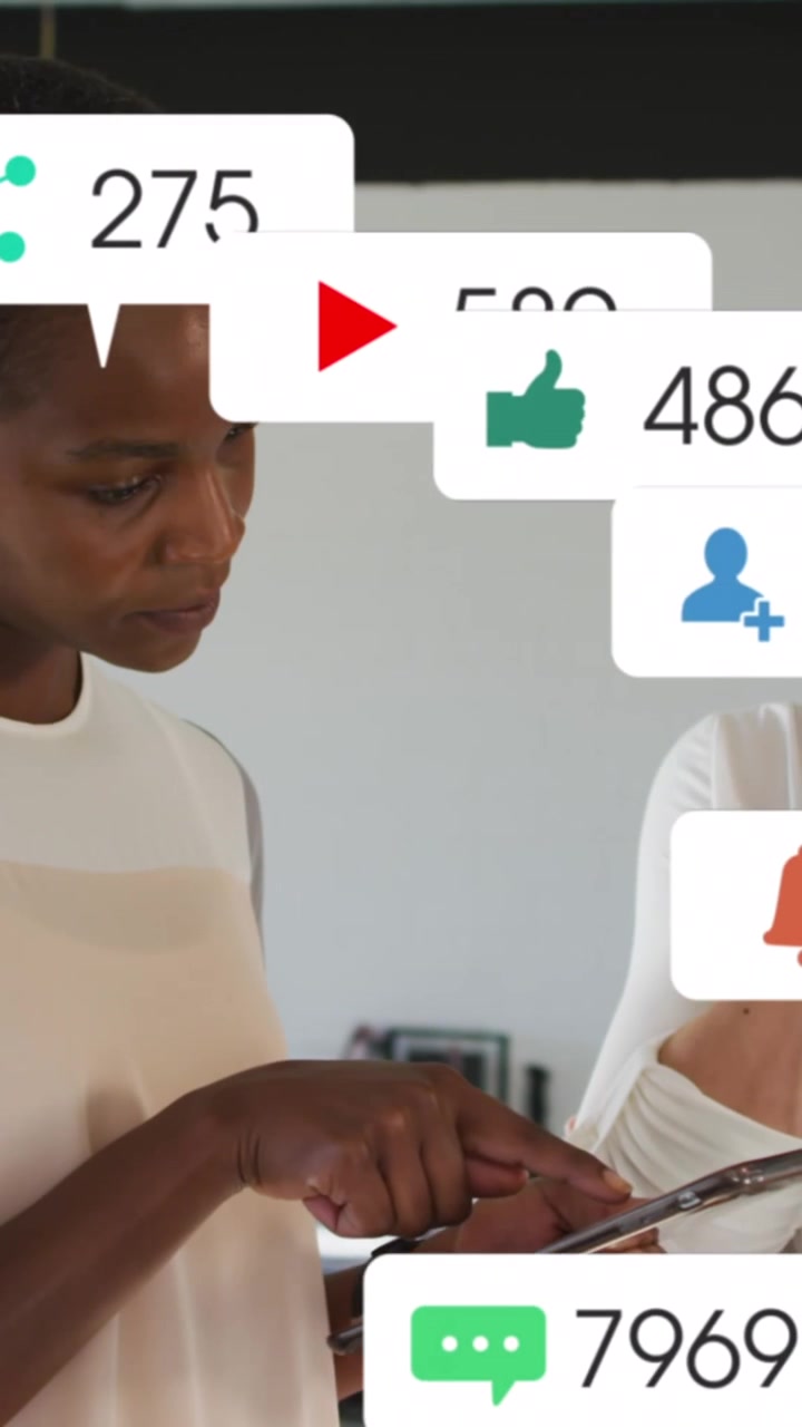 Animation of social media icons and numbers over african american businesswoman using tablet