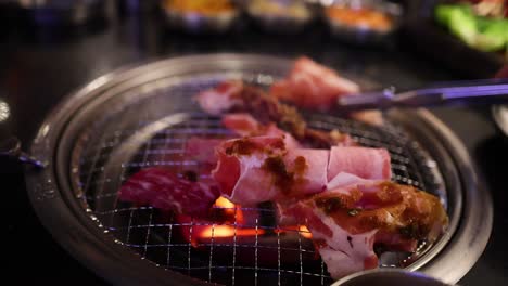 beef and bacon grilling on a barbecue