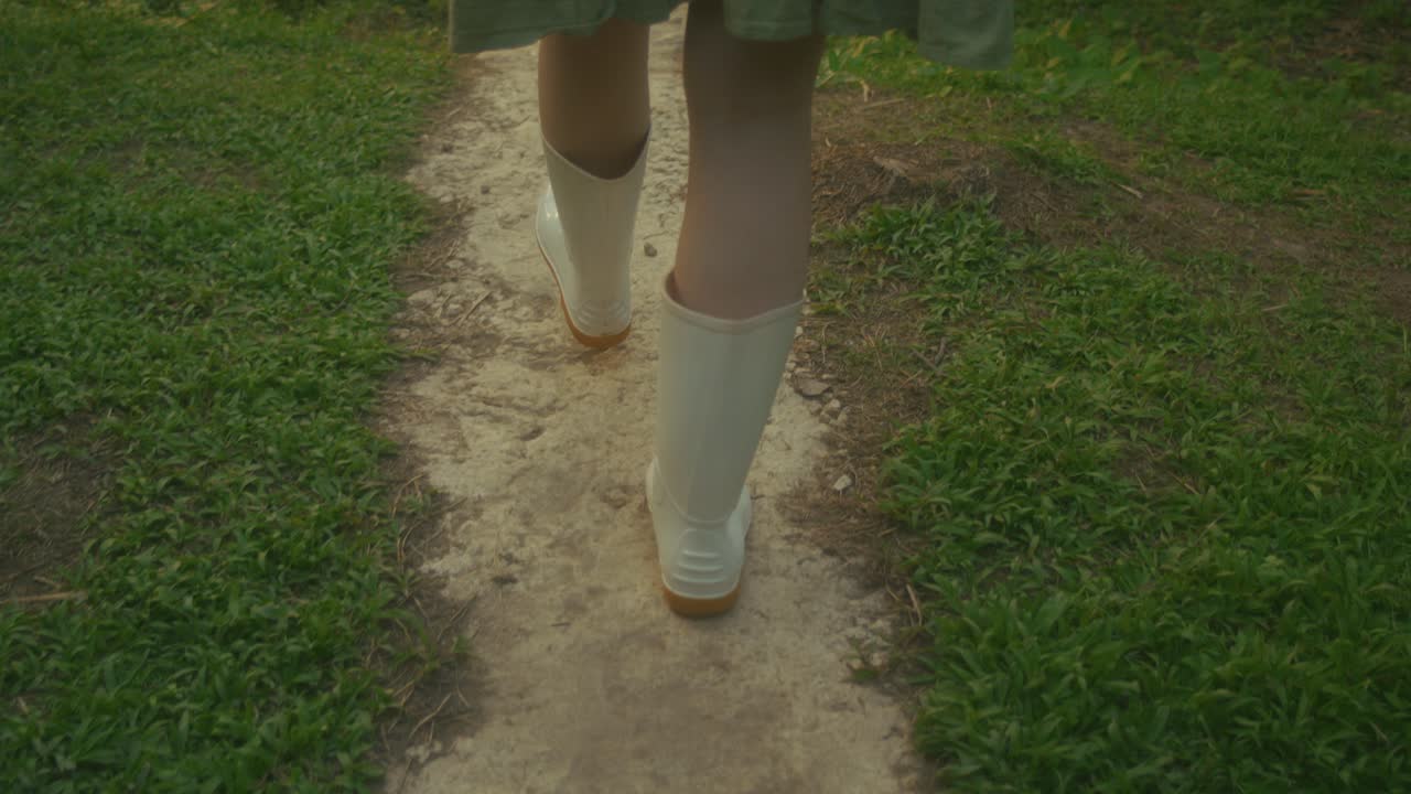 Woman walking in a garden path