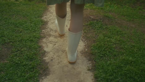 woman walking in a garden path