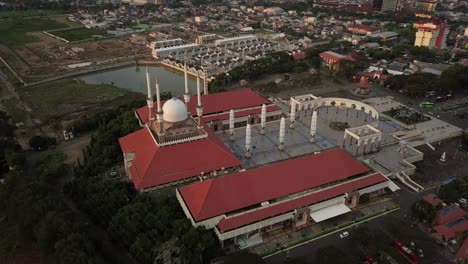 aerial view of the great mosque of central java (majt) in suset time. th sun is orange and the weather is cloudy. bird eye view