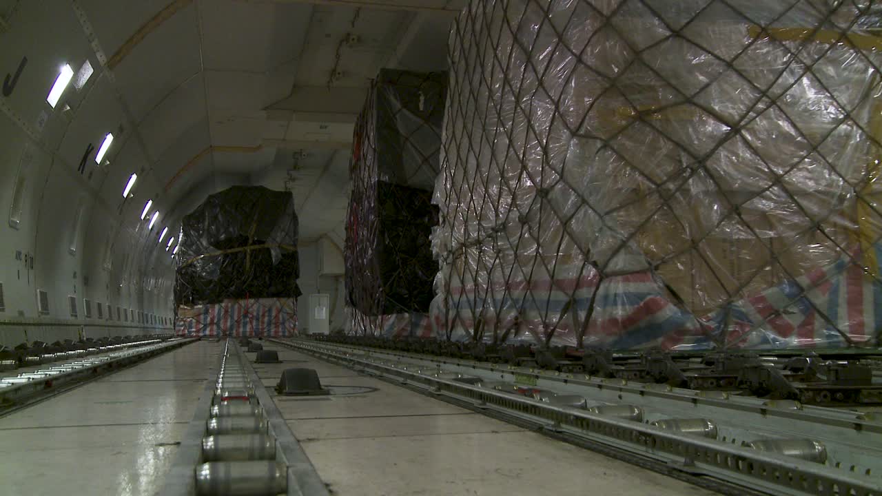 Cargo plane interior with large pallet stacks, calm mood, shipment theme