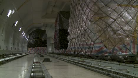 cargo plane interior with large pallet stacks, calm mood, shipment theme