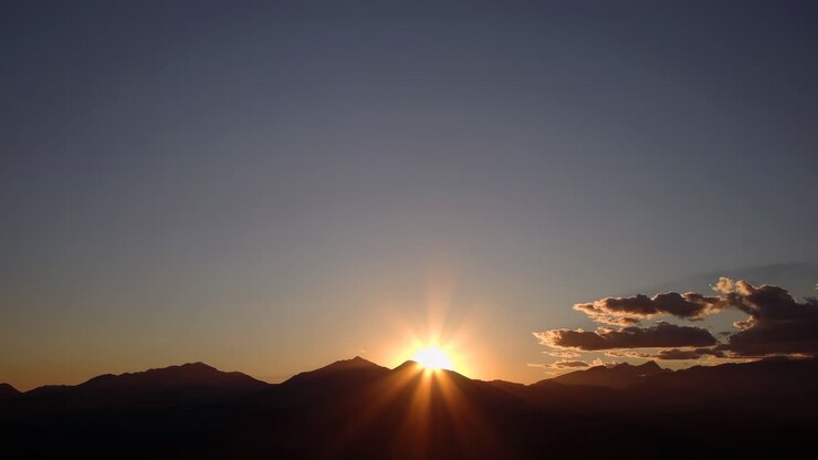 Aerial video captures a stunning sunset over mountains, with a wide-angle view