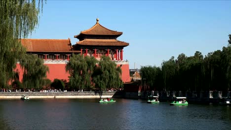 holidaymakers riding paddle boats outside the forbidden city, beijing