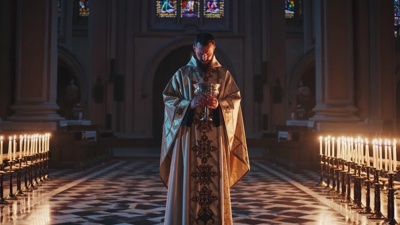 A priest stands solemnly in a dimly lit church, surrounded by candles