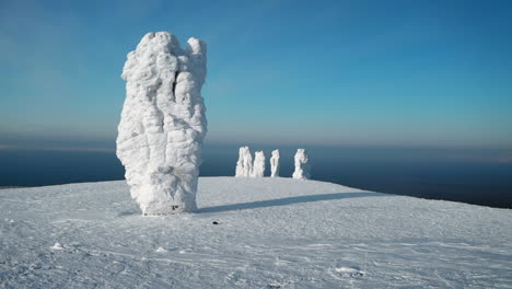 snow-covered stone pillars on a mountain peak