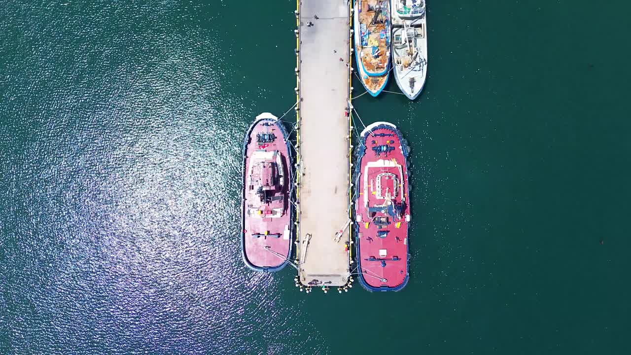 Drone aerial bird's-eye view wharf dock waterfront infrastructure fishing trawlers marine port Eden Twofold Bay Sapphire Coast Australia