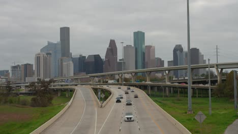 establishing shot of cars on i-45 north freeway with downtown houston in the background