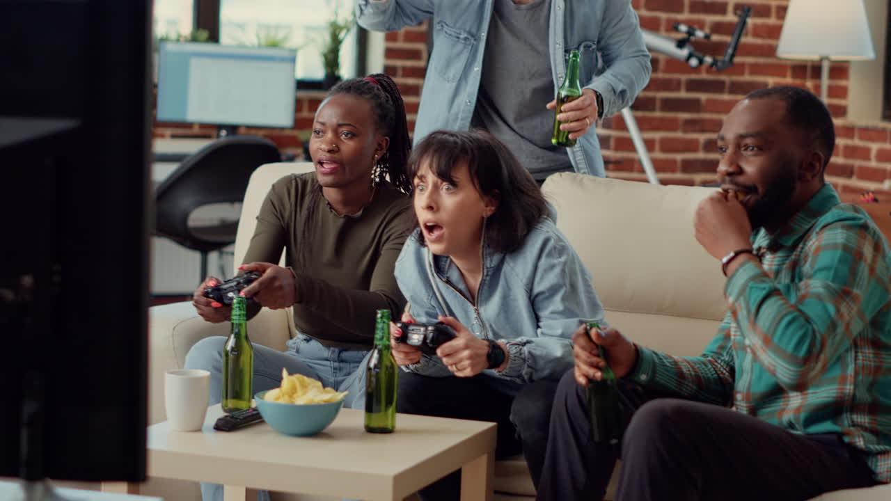Multiethnic group of friends having fun with video games competition