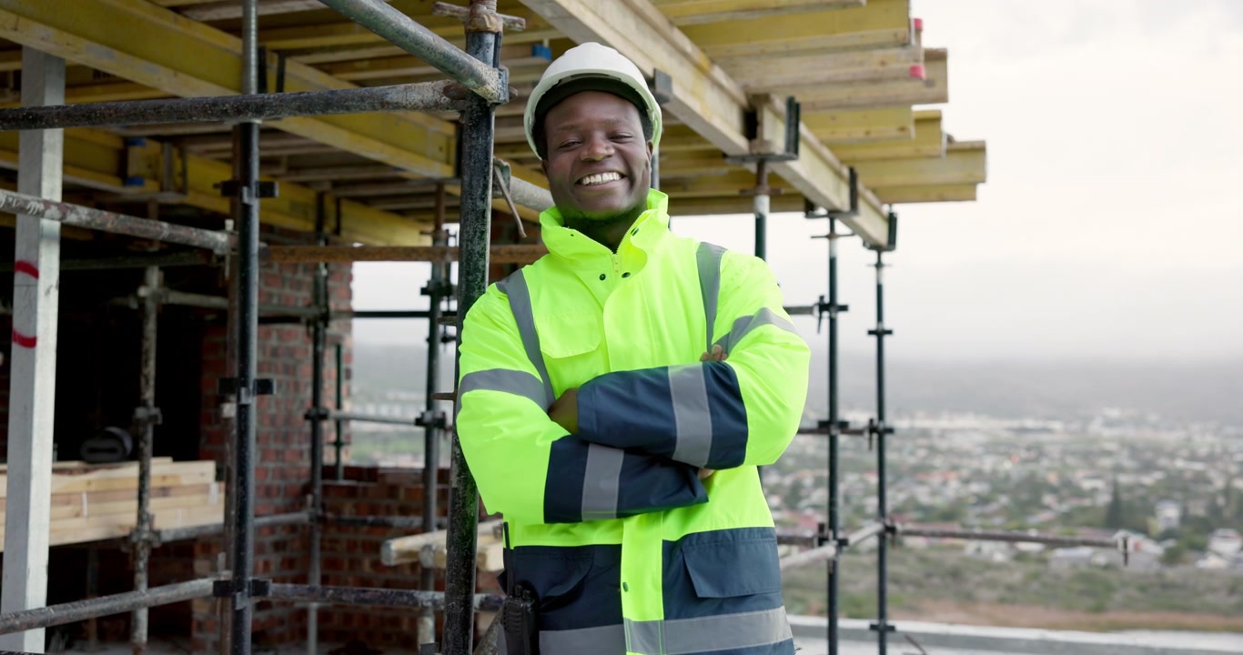 Smiling Construction Worker Standing on Building Site
