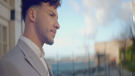 Man in profile view wearing a suit