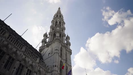 looking up the townhall of brussels against blue summer sky - pov