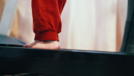 little child walks on modern running machine in room