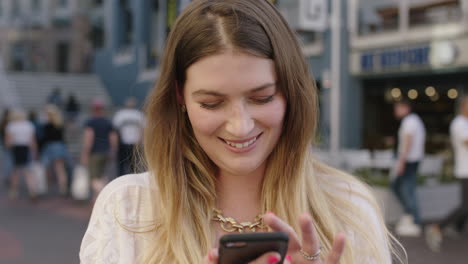 portrait of young happy blonde woman using smartphone social media app browsing online enjoying city lifestyle