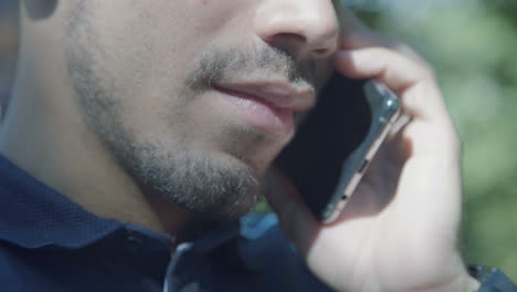 close up shot of male caucasian mouth talking on phone