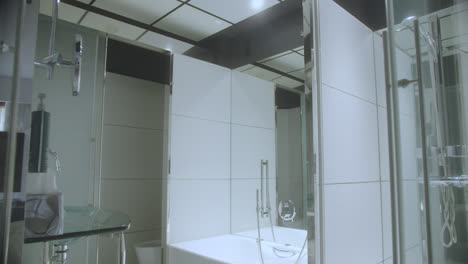 beautiful general shot of an elegant bathroom inside a luxury hotel in spain. ceramic and mirrors of quality material with fine touches.