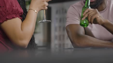 Low-Angle-Shot-Man-and-Woman-Toasting-Drinks-While-On-a-Date