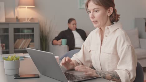 woman having business video call on laptop from home