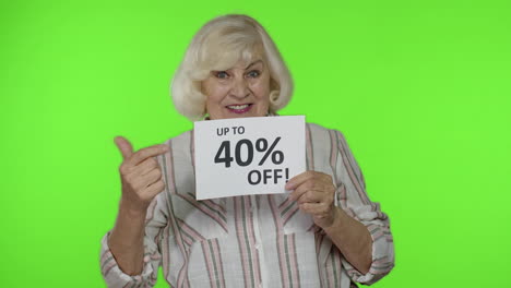 Senior-grandmother-showing-Up-To-40-percent-Off-inscription-sign,-rejoicing-discounts,-low-prices