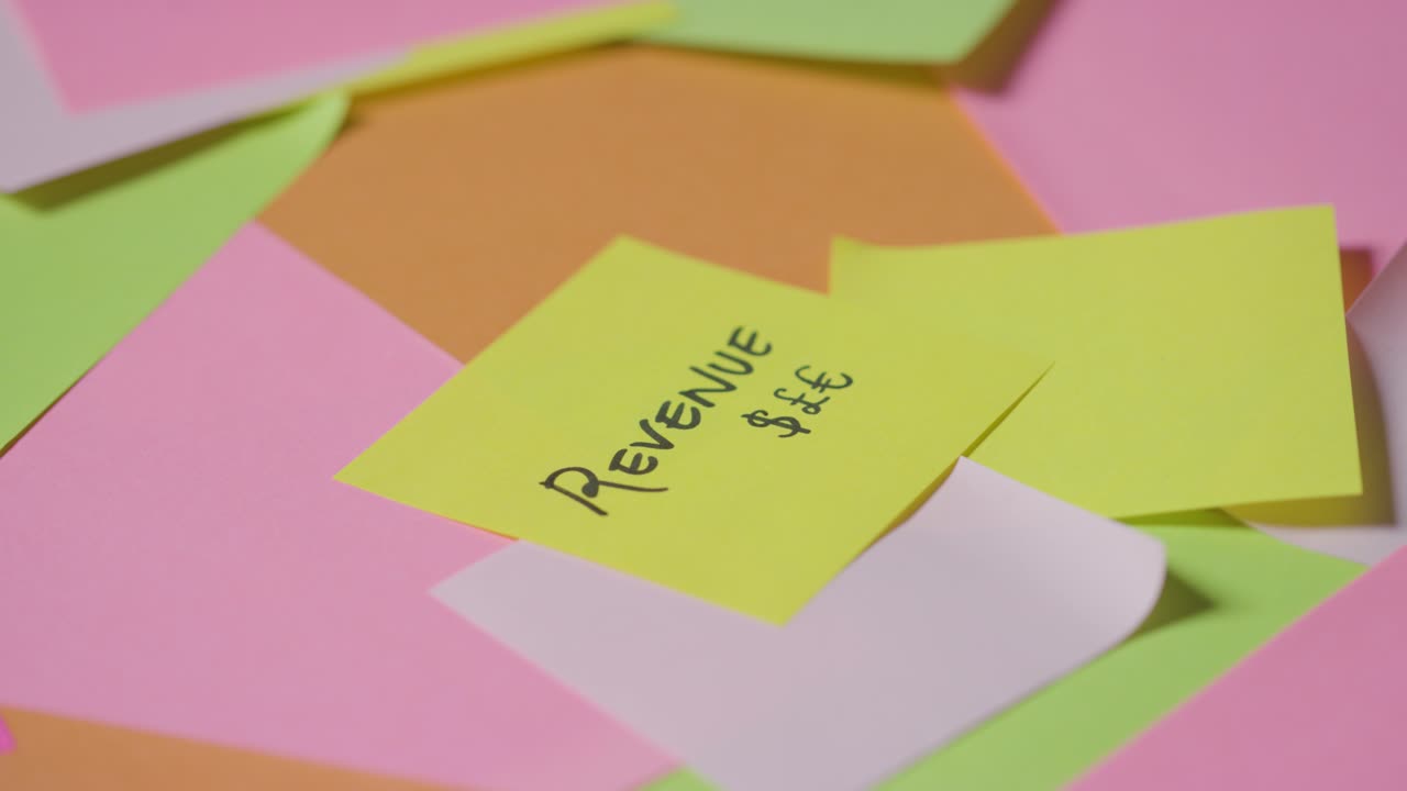 Business Concept Of Revolving Sticky Notes With Revenue Written On Top Note 1