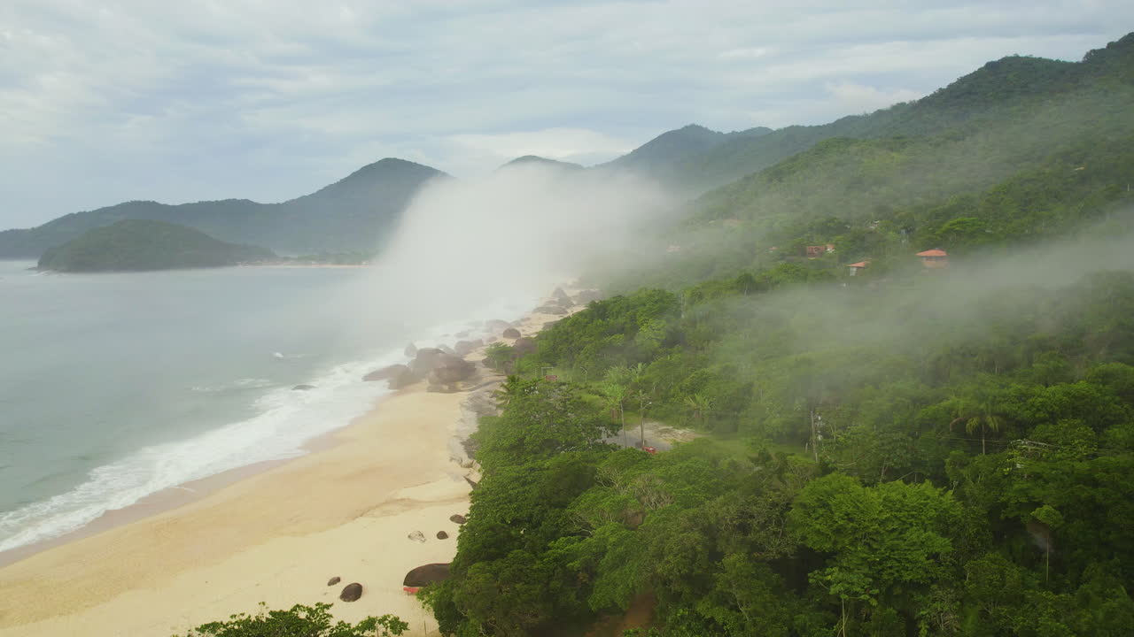 Drone flying along the Trinidade beach, foggy day in Brazil, South America